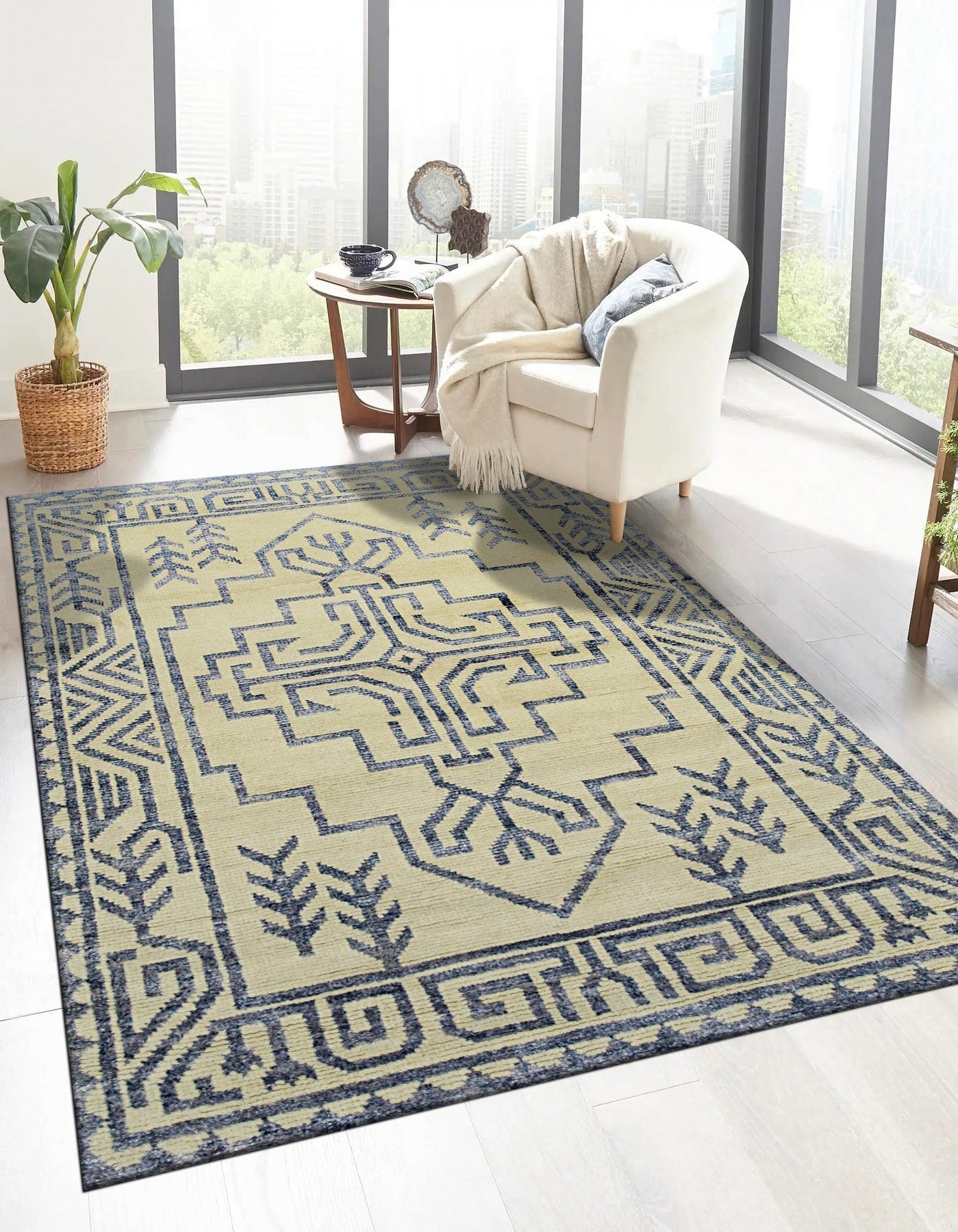 Louie Trara Blue Hand Knotted Wool &amp; Bamboo Silk Rug, its intricate pattern unfurling across the floor in shades of blue.