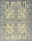 Louie Trara Blue Hand Knotted Wool & Bamboo Silk Rug, showcasing its intricate design of overlapping geometric patterns in shades of blue and cream.