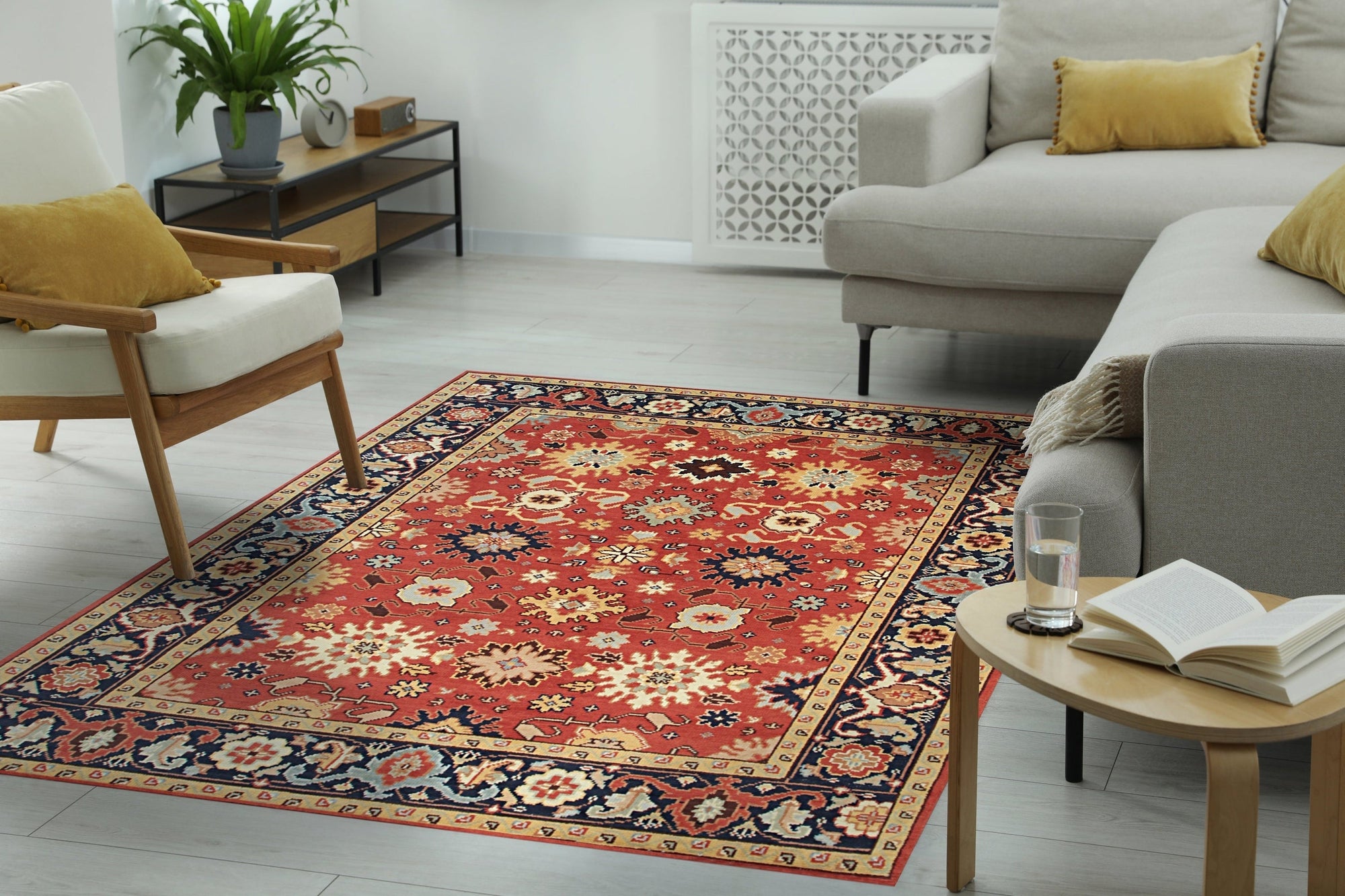 Kira Zinnia Rust Hand Knotted Wool Rug, its vibrant red tones and intricate hand-knotted wool texture anchoring a contemporary living room with a warm, luxurious feel.