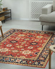 Kira Zinnia Rust Hand Knotted Wool Rug, its vibrant red tones and intricate hand-knotted wool texture anchoring a contemporary living room with a warm, luxurious feel.