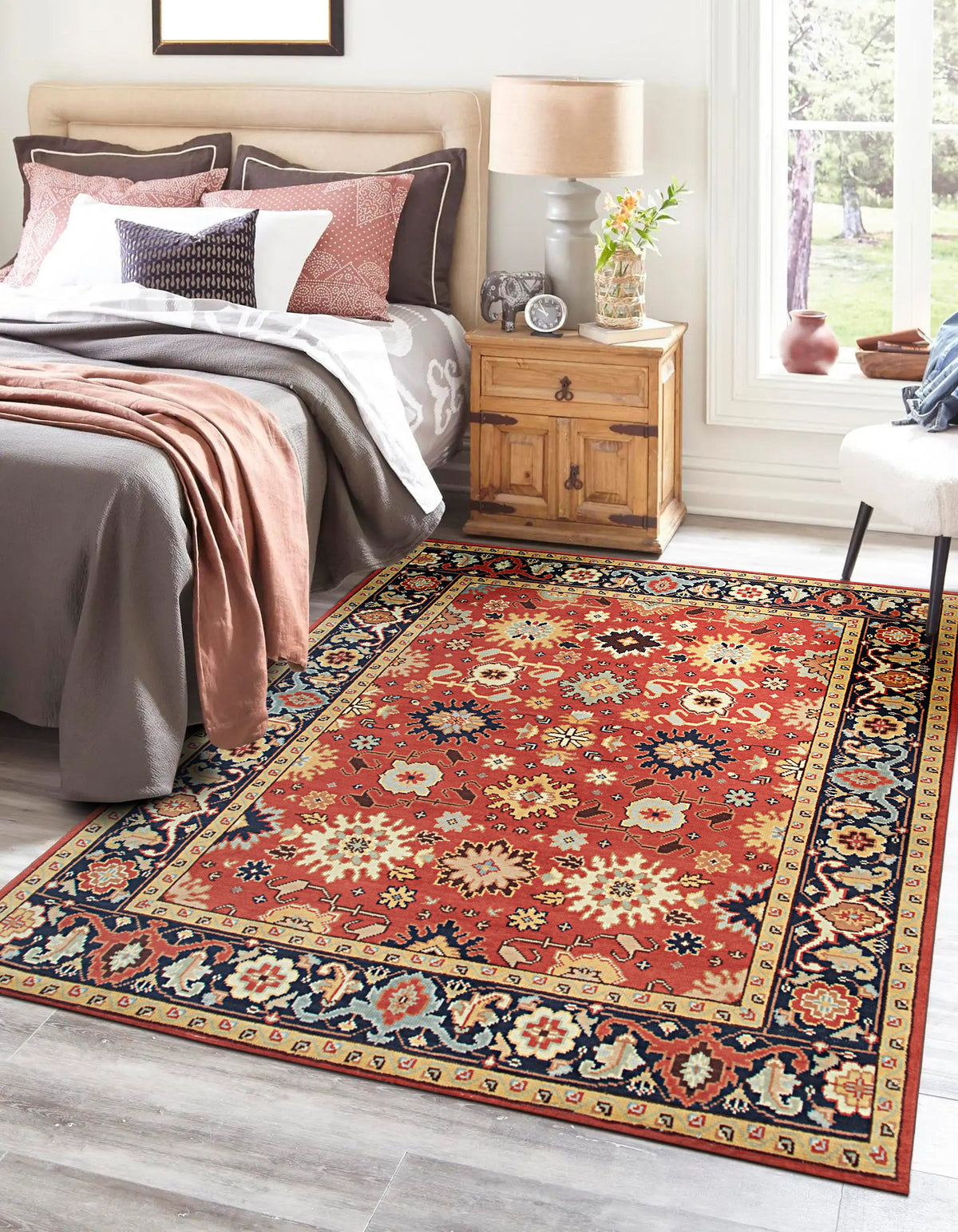 Kira Zinnia Rust Hand Knotted Wool Rug, featuring intricate patterns and rich red hues, partially displayed, showcasing texture and craftsmanship.