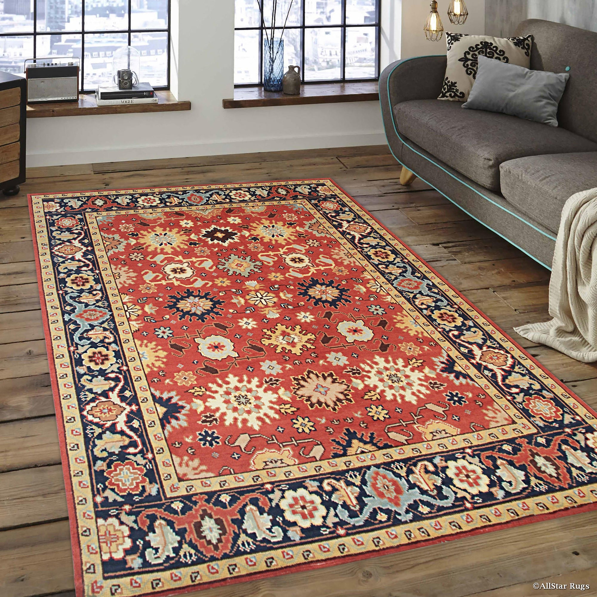 Kira Zinnia Rust Hand Knotted Wool Rug displayed on light hardwood floor, radiating warmth with its vibrant red hues and intricate hand-knotted design.
