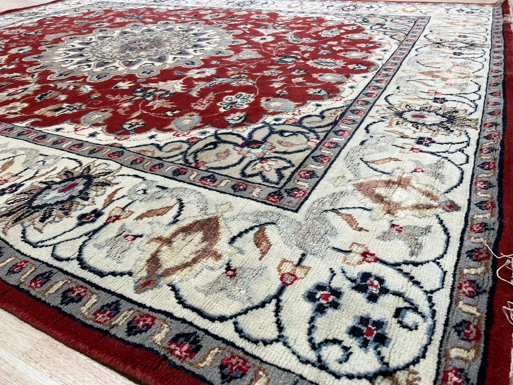 Selene Trara Red Hand Knotted Wool &amp; Silk Rug, a rich red rug showcasing intricate hand-knotted details with subtle silk highlights, laying flat with subtle variations in texture and shading.