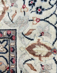 Here's the alt text for the rug image, following your guidelines:
 
 Selene Trara Red Hand Knotted Wool & Silk Rug, showcasing a complex geometric pattern in vibrant reds, creams, and blues, hand-knotted for exceptional texture and depth on a wooden floor.