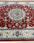 Selene Trara Red Hand Knotted Wool & Silk Rug, showcasing a vibrant red palette and intricate, possibly geometric or floral, design, laying flat and inviting touch.