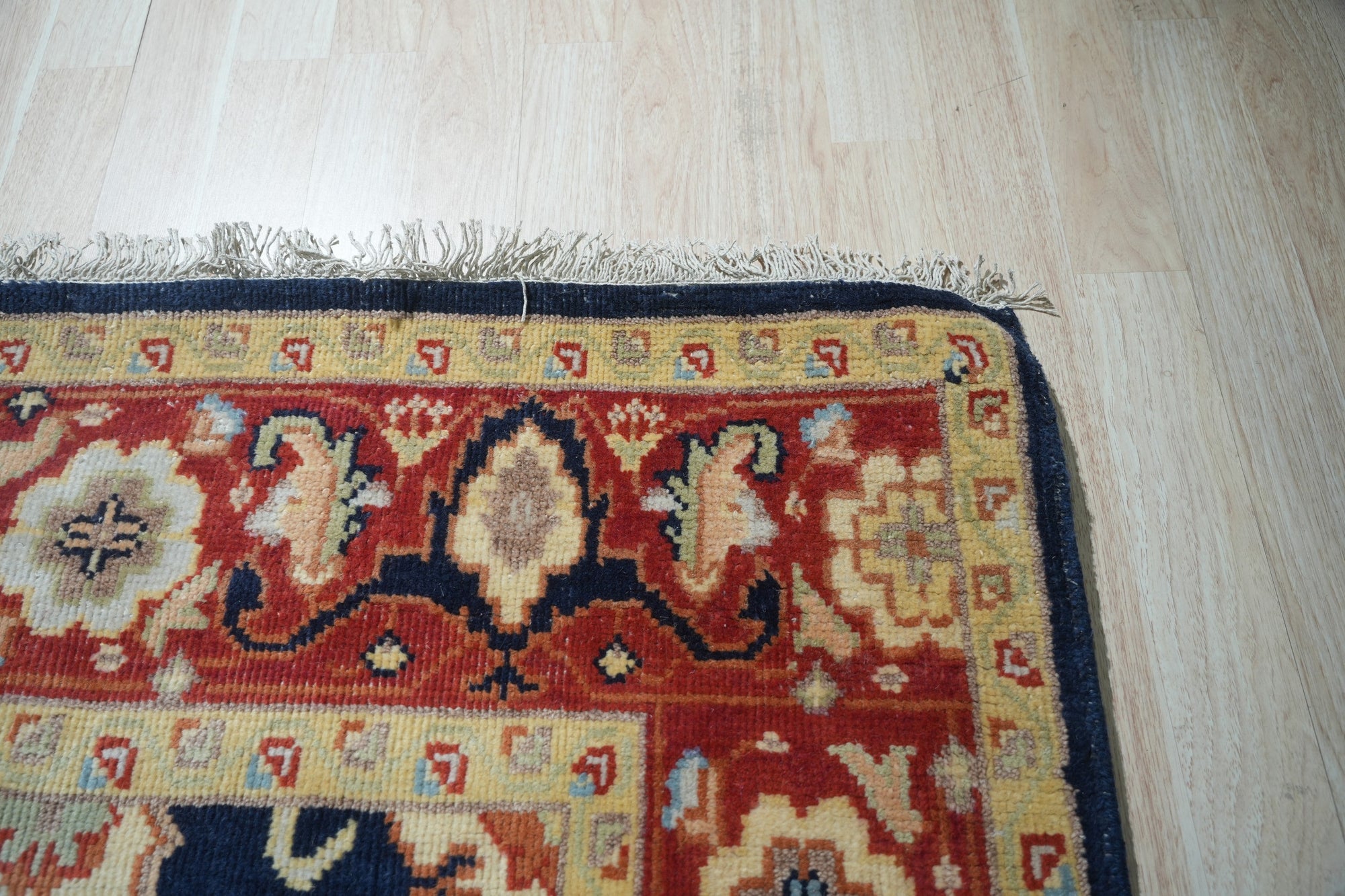 Violet Exquisite Navy Hand Knotted Wool Rug, a plush navy wool rug with a subtle, elegant pattern, softly illuminating a warmly lit interior.