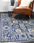 Alluring Freya Blue Hand Knotted Wool Rug displayed in a bright living room, its intricate, cool-toned pattern anchoring the space.