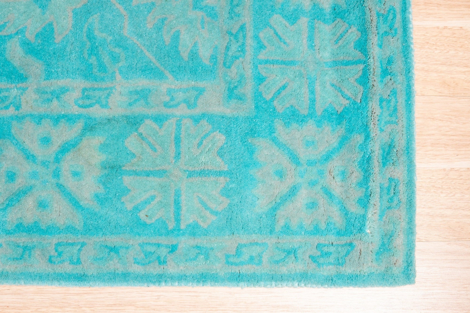 Louie Oriental Turquoise Hand Tufted Wool Rug, showcasing its vibrant turquoise hues and intricate Oriental design.