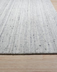 Delicate Striped Silver Handmade Wool Rug, its subtle silver stripes and plush wool texture bringing understated elegance to a bright, airy living room space.