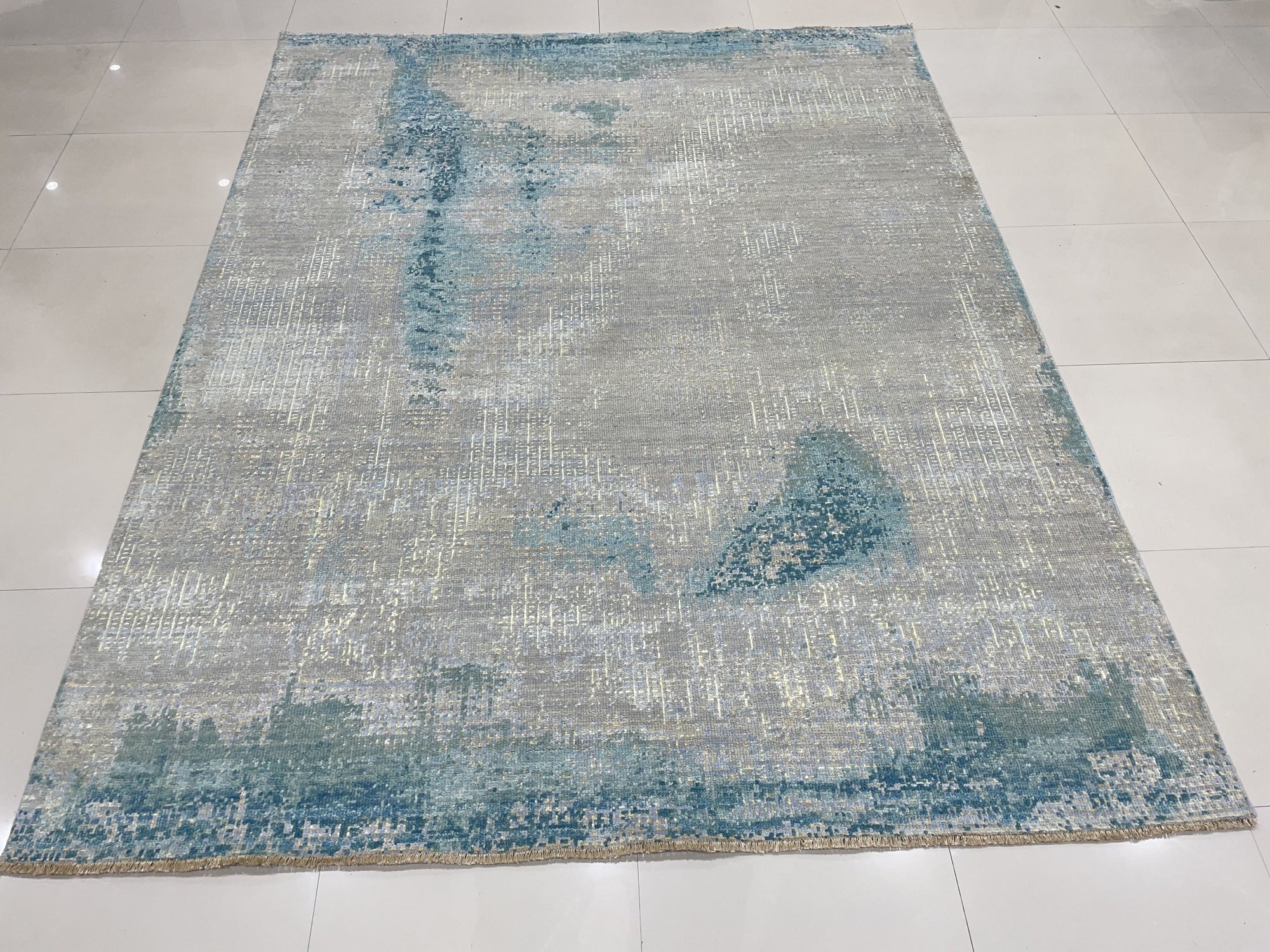 Stylish Sumptuous Aqua Hand Knotted Wool Rug, a calming expanse of hand-knotted wool in varying shades of aqua, softening a warmly lit interior.