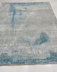 Stylish Sumptuous Aqua Hand Knotted Wool Rug, a calming expanse of hand-knotted wool in varying shades of aqua, softening a warmly lit interior.