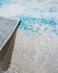 Stylish Sumptuous Aqua Hand Knotted Wool Rug, its soft aqua hues and hand-knotted texture inviting warmth to any space, displayed as part of a larger collection.