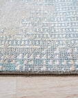 Stylish Sumptuous Aqua Hand Knotted Wool Rug, showcasing its plush texture and intricate knotting in a living room setting. Aqua hues blend seamlessly, complementing the room's decor.