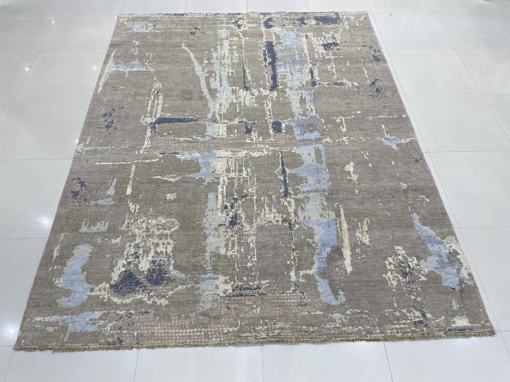 Clara Stylish Gray Hand Knotted Wool Rug, soft gray wool pile featuring a subtle geometric pattern, partially visible showcasing texture and construction.