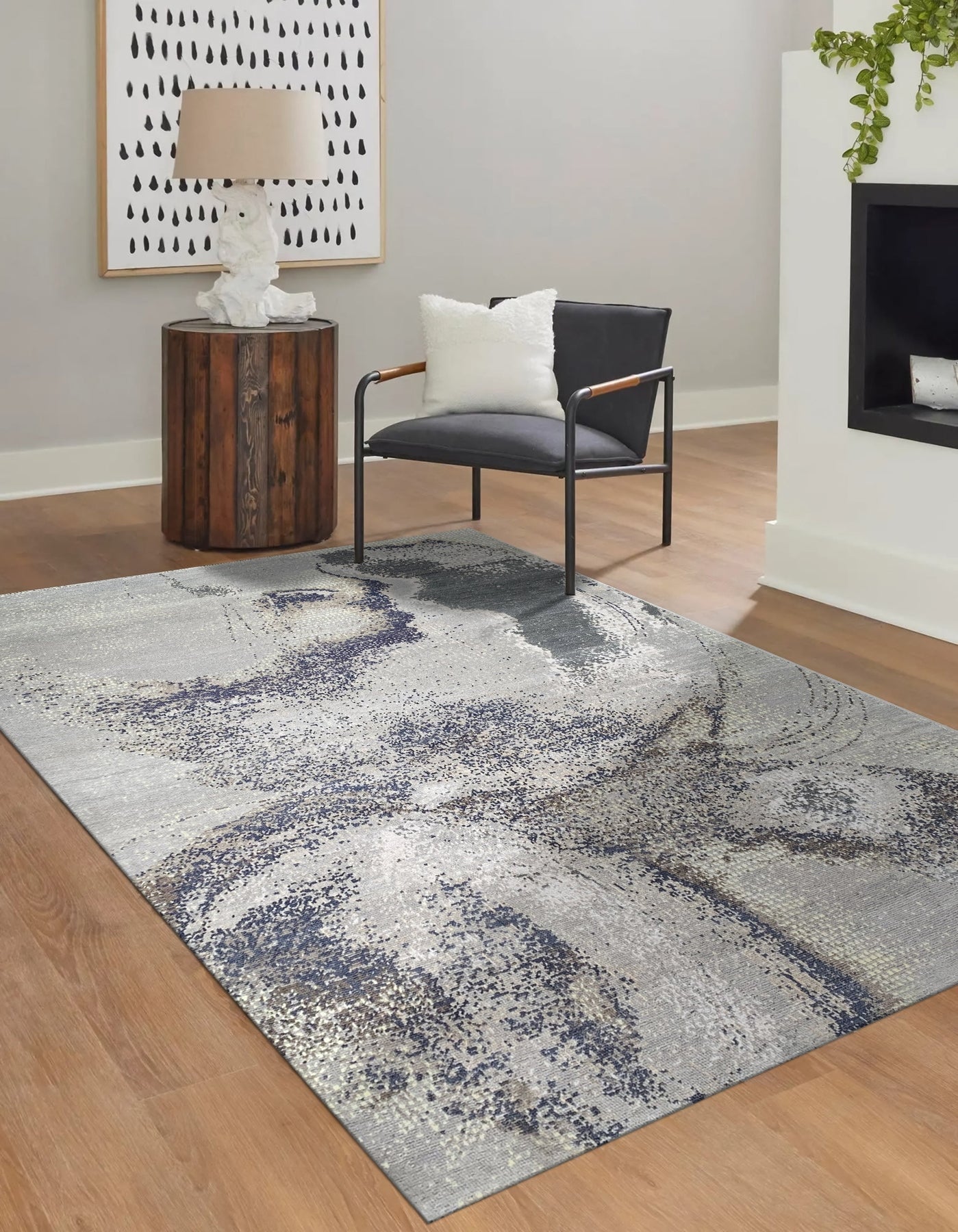 Lydia Cassandra Gray Hand Knotted Wool Rug, its subtle gray tones and hand-knotted texture lending a sophisticated touch to a softly lit living space.