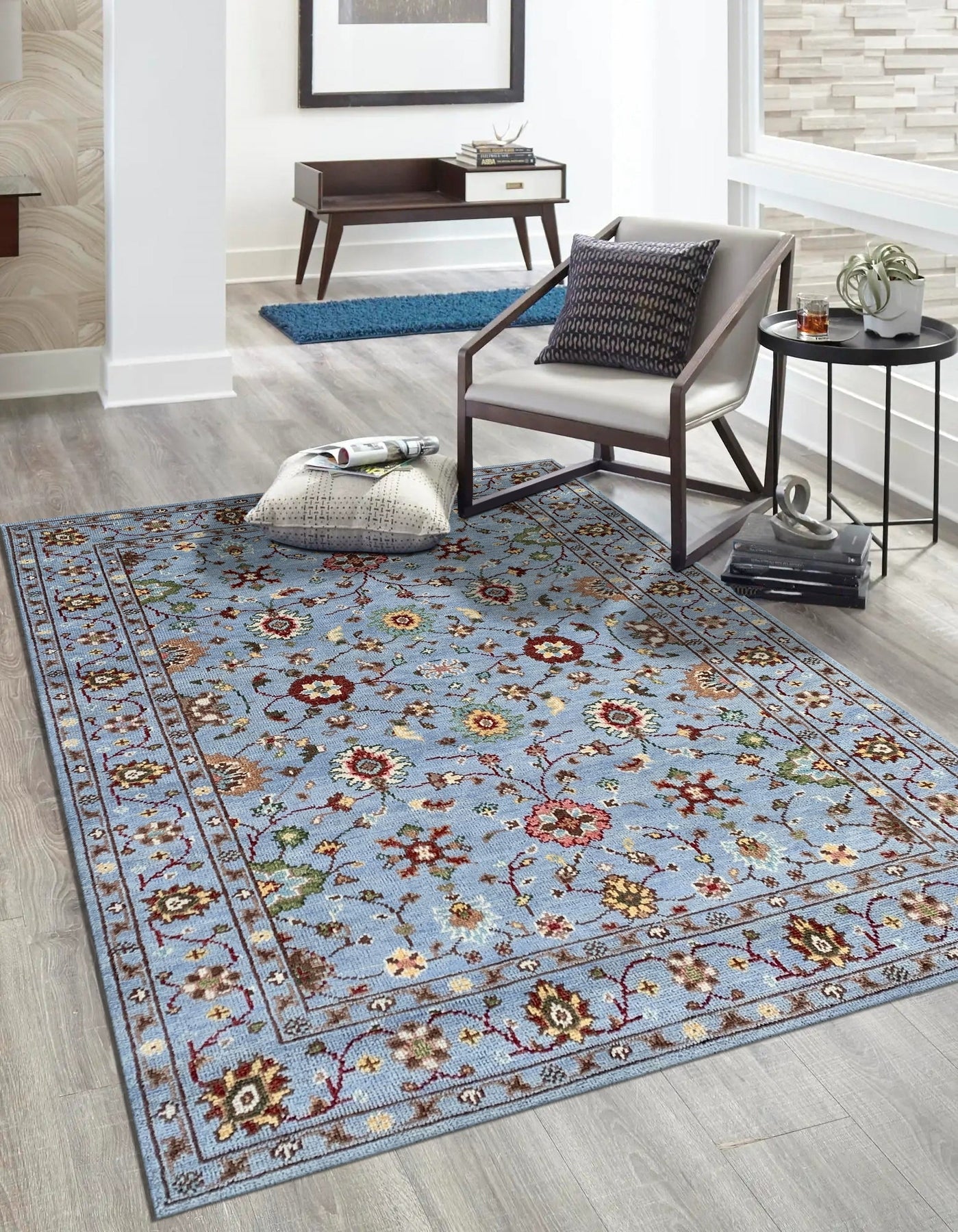 Elena Oriental Blue Hand Knotted Wool Rug, showcasing a detailed traditional design with intricate patterns in shades of blue, ivory, and subtle accents, displayed in a well-lit room setting.