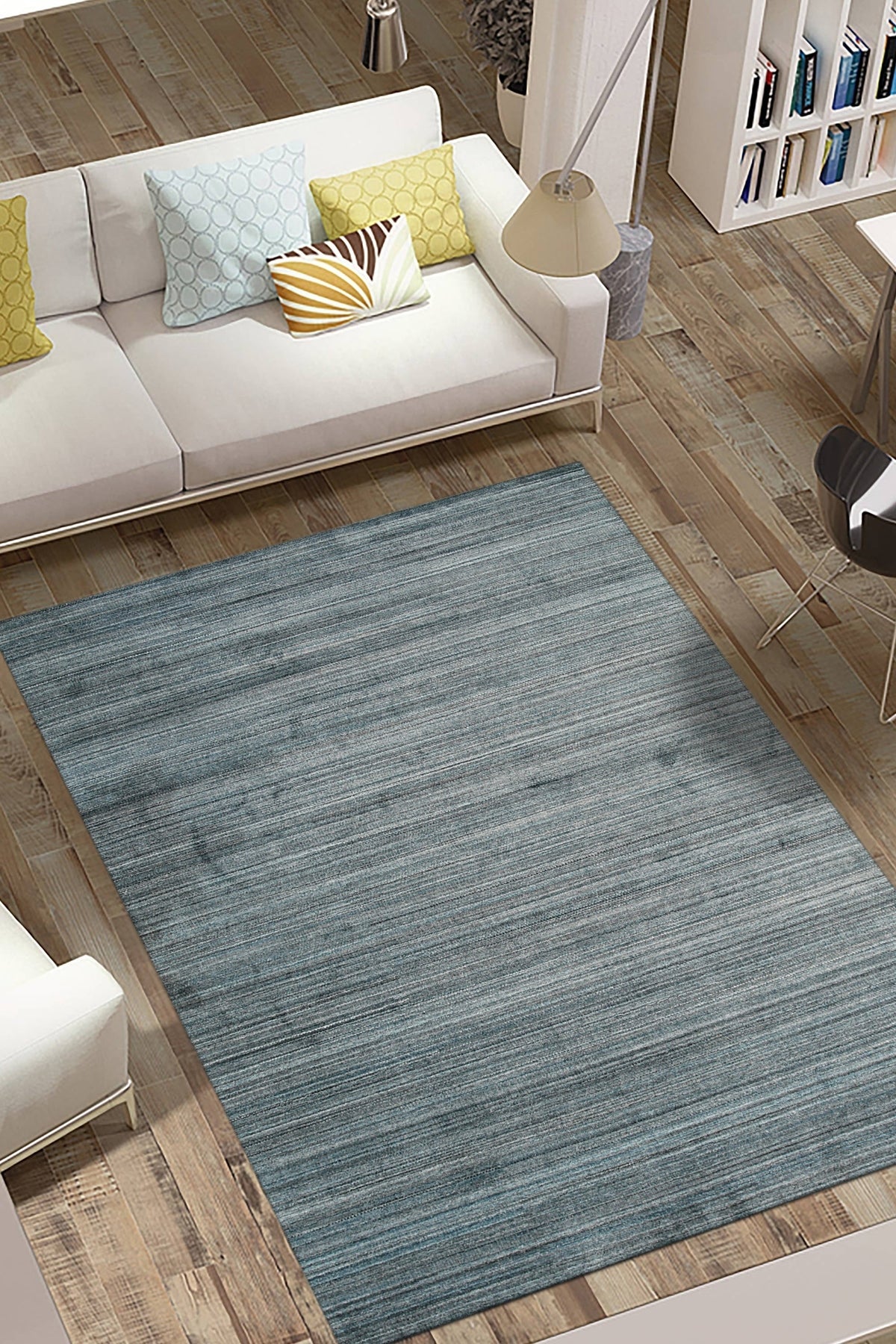 Para Elena Blue Handmade Wool Rug graces a living room, its intricate pattern of blues and creams anchoring the space. Woven wool construction brings warmth and texture to the scene, complementing the room's neutral palette.