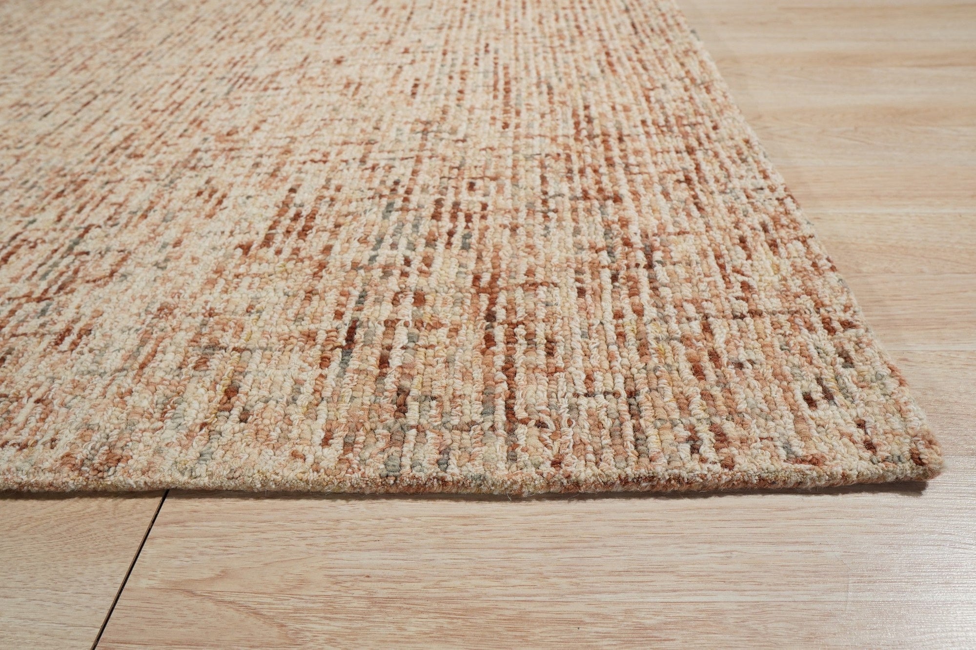 Laine Inviting Brown Hand Tufted Wool Rug, showcasing its soft, brown wool texture and inviting warmth within a staged living room setting.