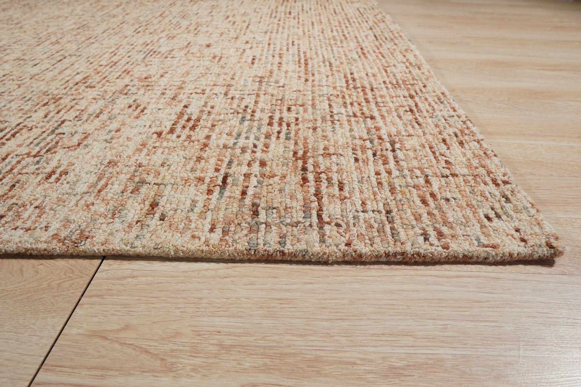 Laine Inviting Brown Hand Tufted Wool Rug, filling a living room space with its warm brown tones and plush texture.