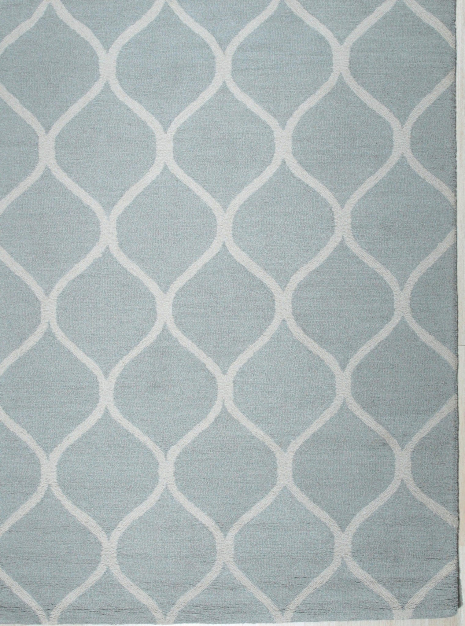 Handcrafted Laine Light Green Hand Tufted Wool Rug styled in a modern living room - area rug lifestyle photo
