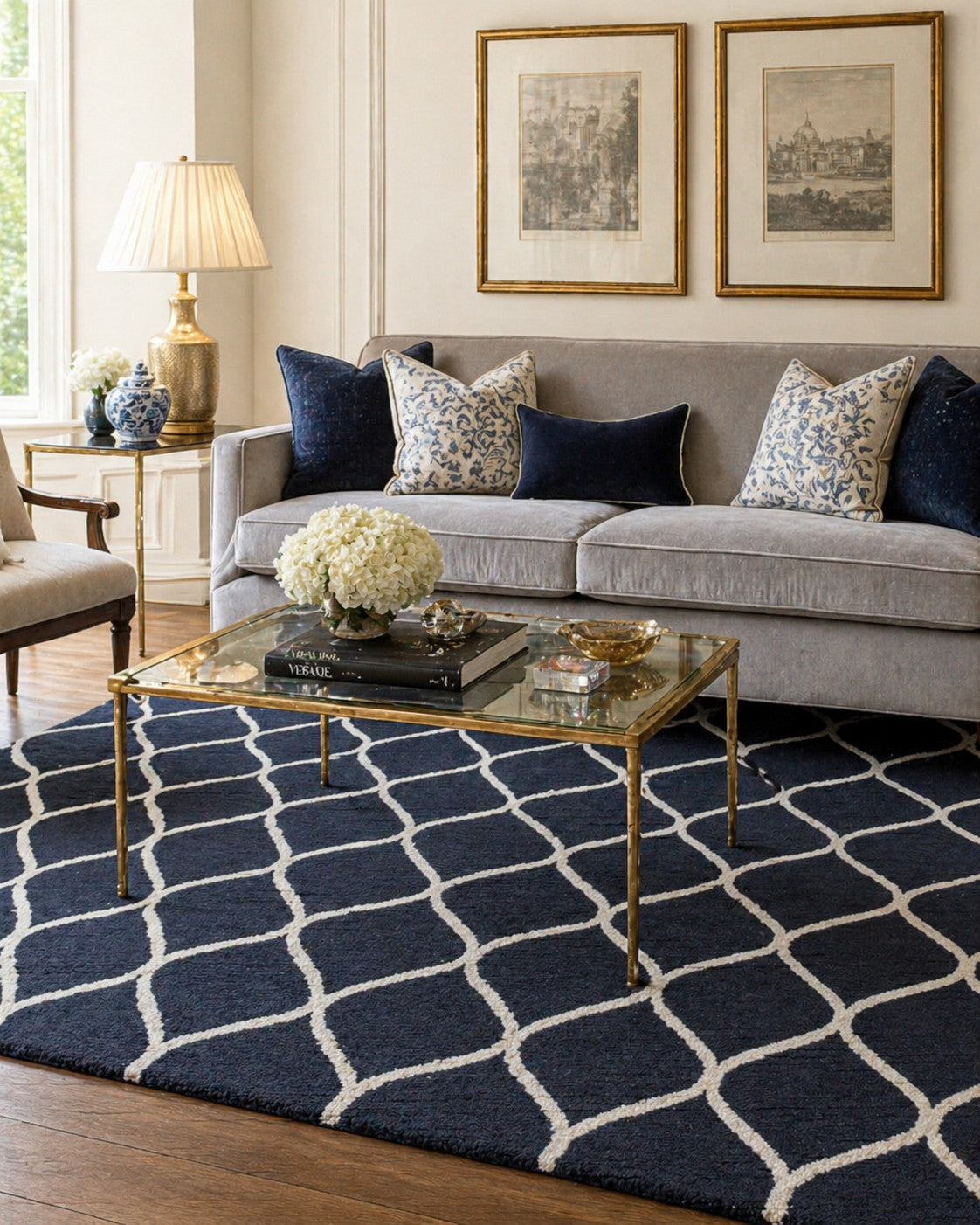 Sloane Willow Navy Hand Tufted Wool area rug styled in a sophisticated living room with grey velvet sofa and brass accents - lifestyle photo