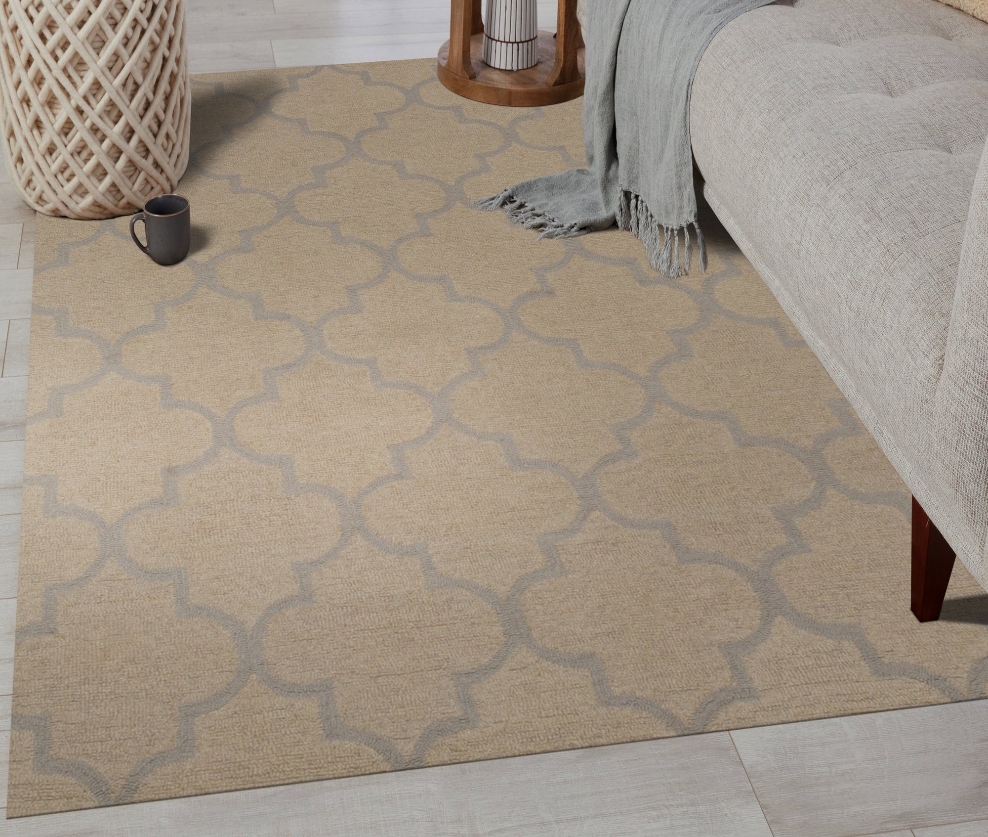 Zinnia Trellis Beige Hand Tufted Wool Rug graces a warmly lit living room, its neutral palette complementing the surrounding furniture. Hand-tufted wool construction provides a soft texture underfoot, while the trellis pattern adds subtle visual interest to the space.