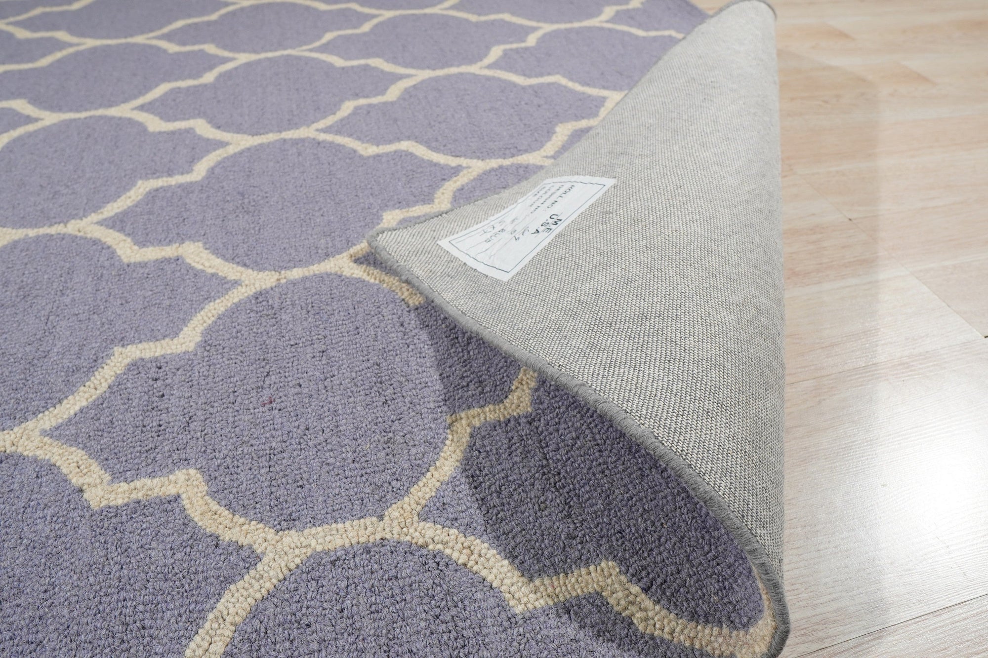 Celia Moroccan Light Purple Hand Tufted Wool Rug, a light purple wool rug with a hand-tufted construction, seen in a well-lit interior space showcasing its texture and subtle Moroccan-inspired pattern.