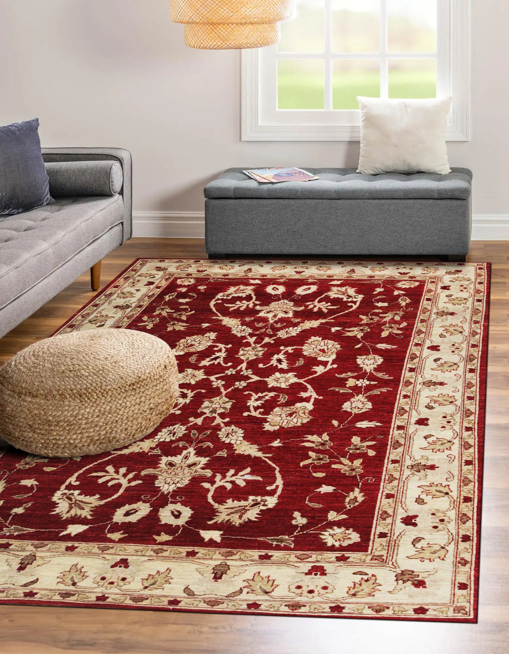 Rustic Agra Red Hand Knotted Wool Rug, showcasing warm reds and intricate patterns, lays grounded against a hardwood floor. The hand-knotted wool construction lends texture and depth to the traditional design, inviting warmth and sophistication into the room.