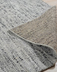 Refined Exquisite Gray Hand Knotted Silk Rug, its shimmering silk pile displayed in a detailed close-up showcasing intricate hand-knotted craftsmanship and subtle tonal variations within the gray color palette.