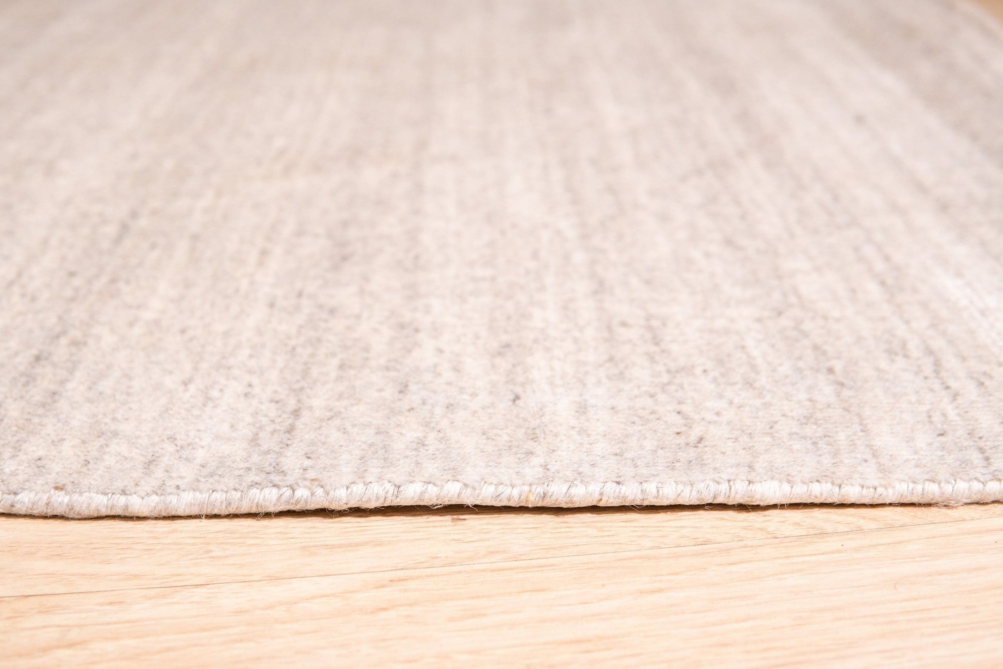 Maya Unique Beige Handmade Wool &amp; Viscose Rug, its soft beige tones and subtle sheen adding warmth to a modern living space, showcasing the blend of wool and viscose fibers.