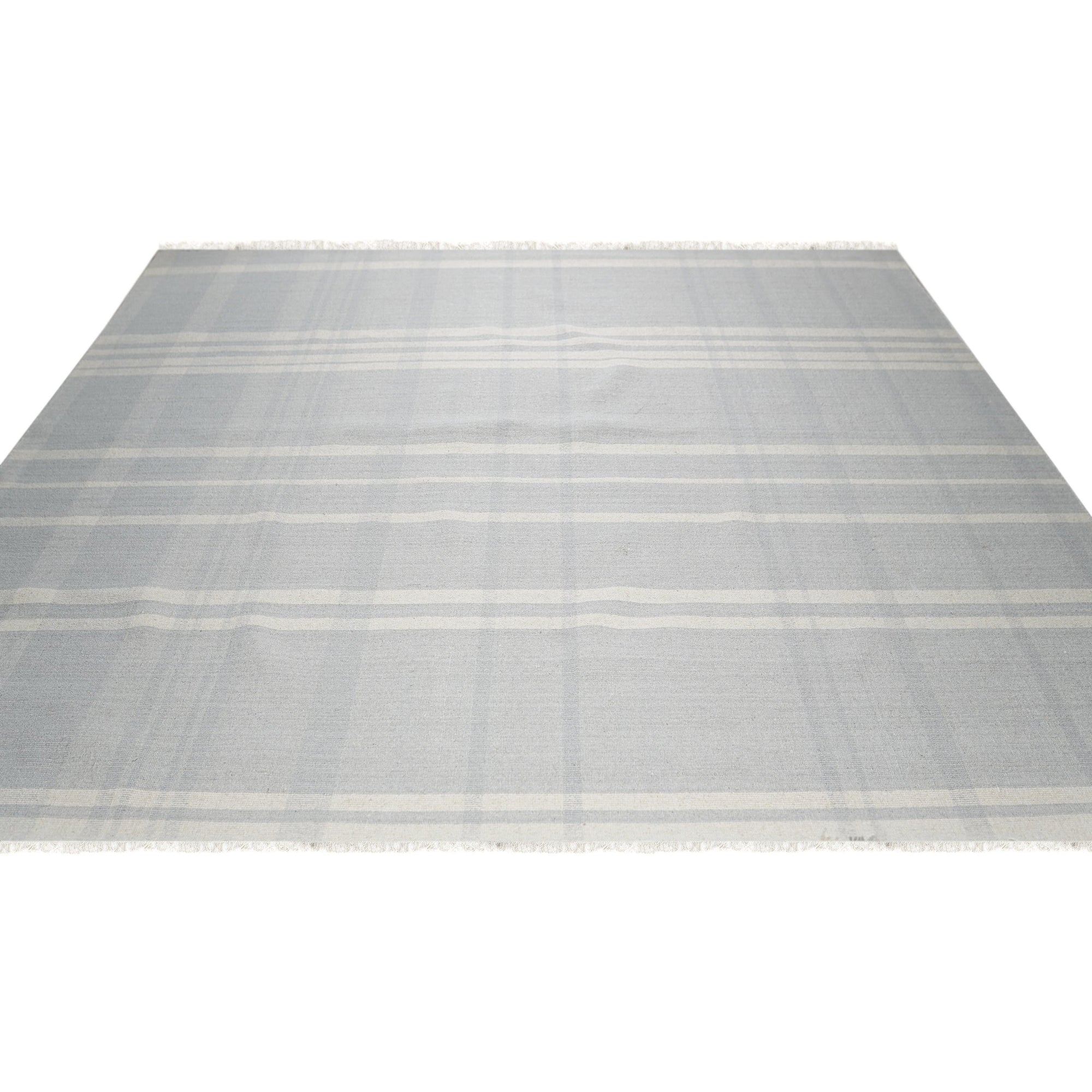 Dazzling Fiona White Flatweave Wool Rug, a pristine white wool rug with subtle texture, lies softly on a light hardwood floor.