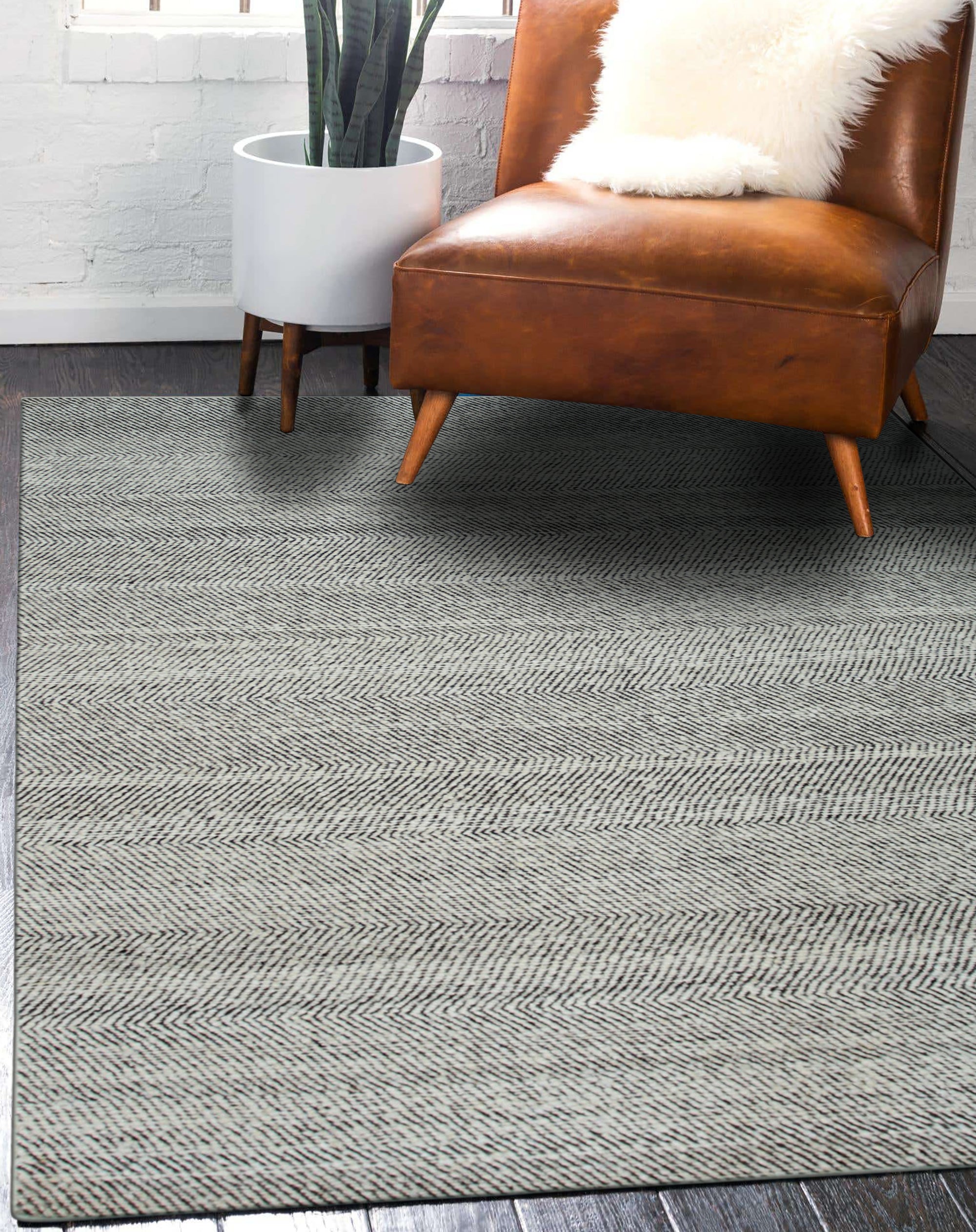 Louie Harlow White Handmade Wool Rug, a textured field of creamy white wool, subtly patterned, fills a bright, airy space creating a cozy, inviting atmosphere.