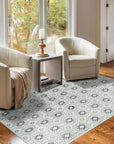 Trara Giselle Blue Hand Knotted Rug, showcasing intricate hand-knotted construction and a serene blue palette, softening a bright living space with warm wood flooring and natural light.