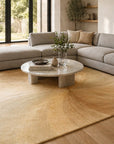 Sleek Sloane Beige Hand Tufted Wool Rug styled in a modern contemporary living room with grey sectional sofa and marble coffee table - area rug lifestyle photo