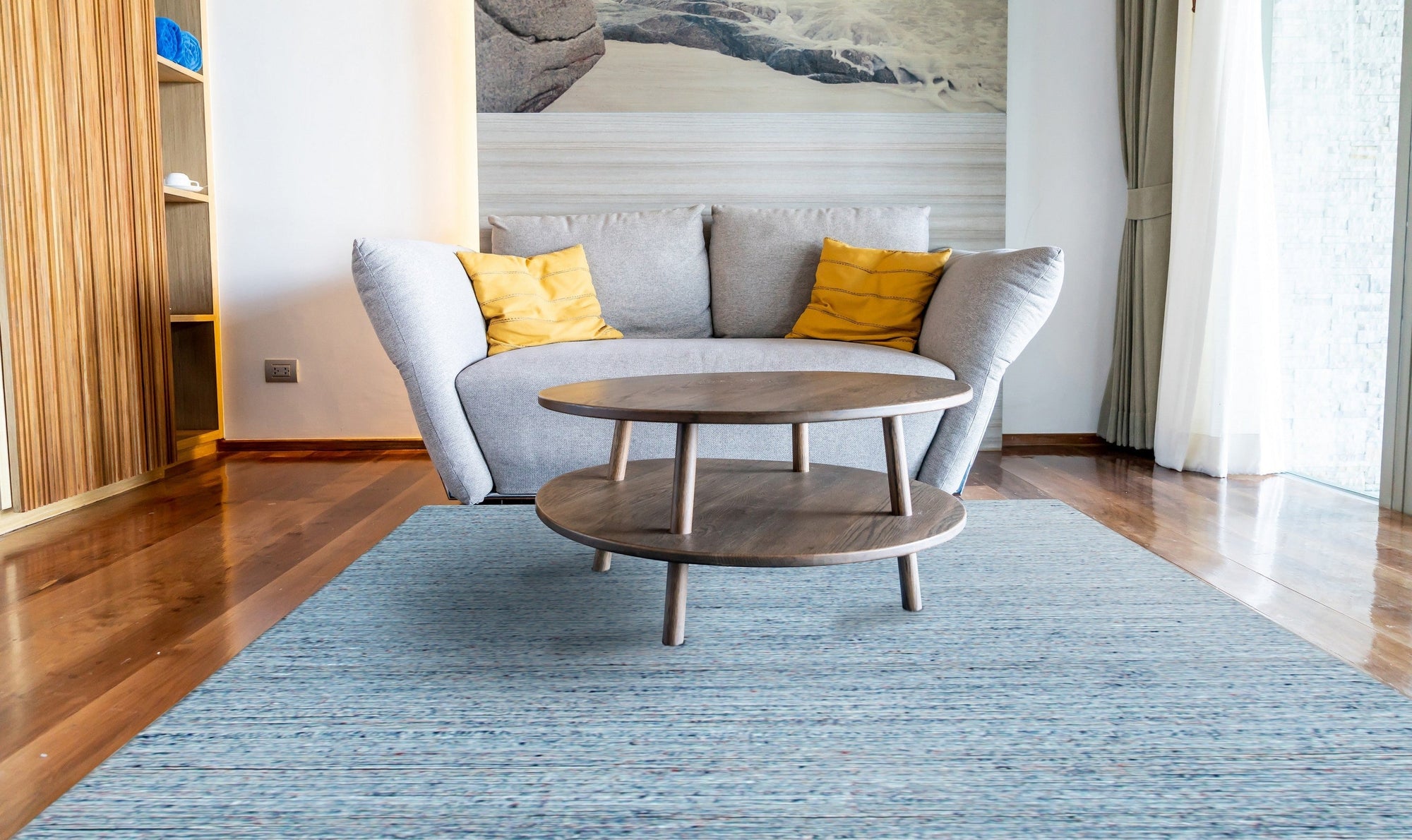 Isla Trendy Blue Handmade Wool Rug, vibrant blue and cream tones blend in a dynamic, abstract pattern under a modern living room setting, showcasing its plush wool texture and hand-made construction.