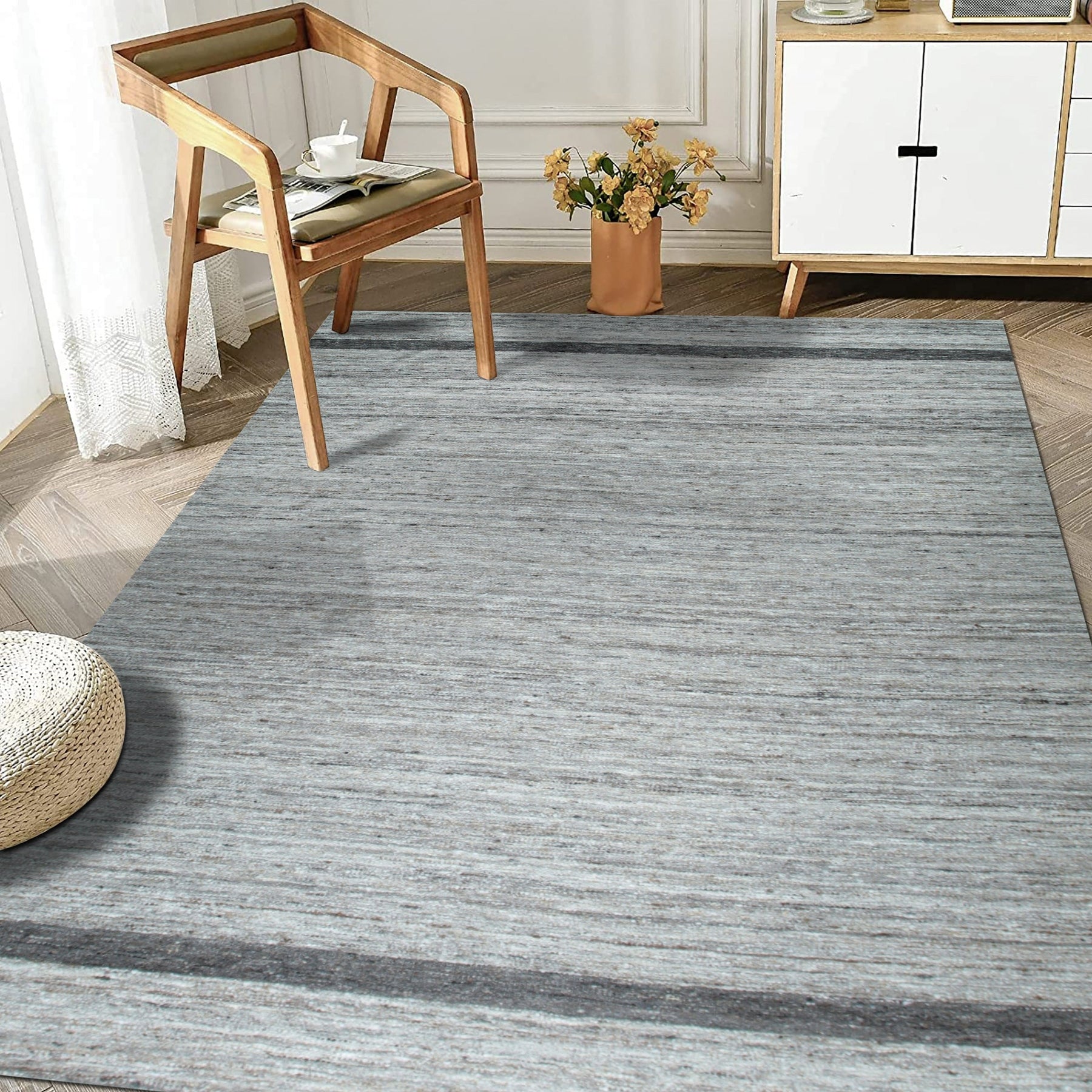 Lila Violet Light Gray Flatweave Wool Rug, featuring subtle gradations of color in a living room setting, adds a touch of serene sophistication to the space.