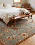 Amara Elegant Gray and Gold Machine Made Wool Rug in a bedroom