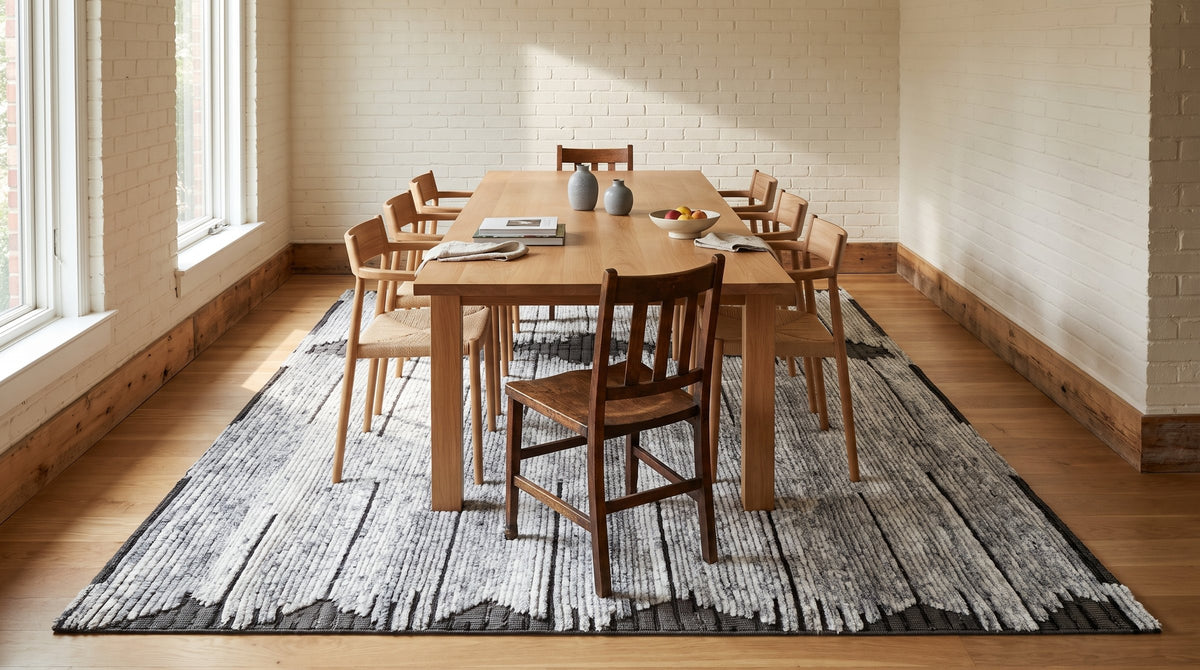 Amara Majestic Gray Hand Knotted Wool Rug in a dining room