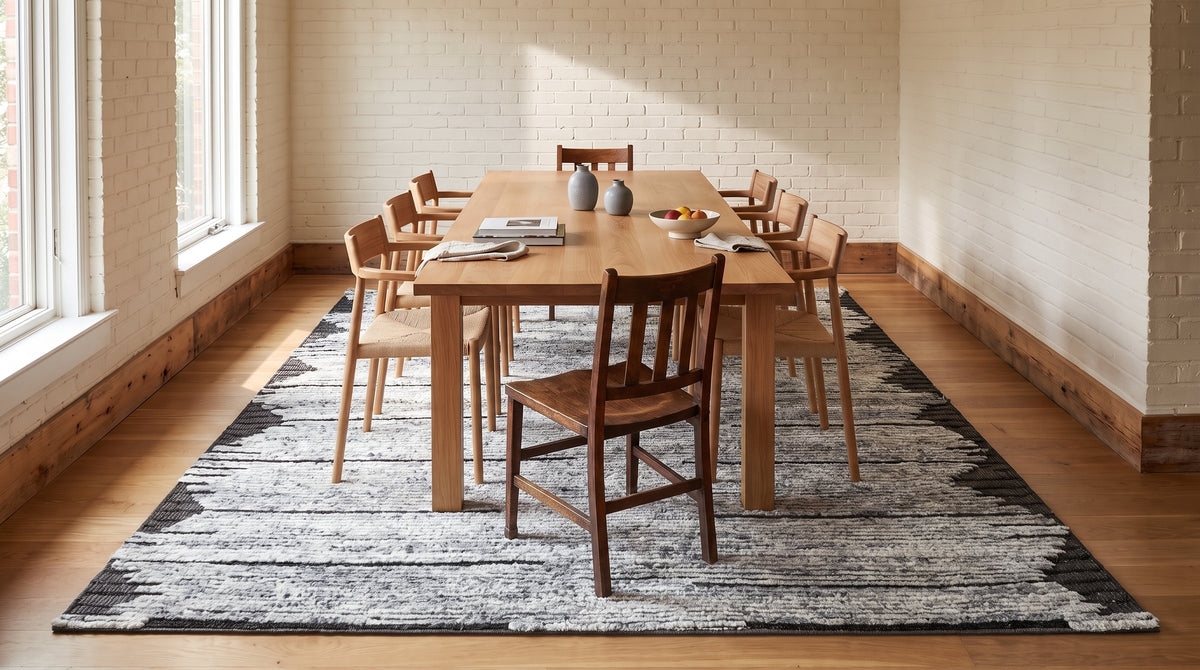 Amara Majestic Gray Hand Knotted Wool Rug in a dining room