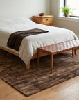 Artistic Brown Hand Knotted Wool Rug in a bedroom