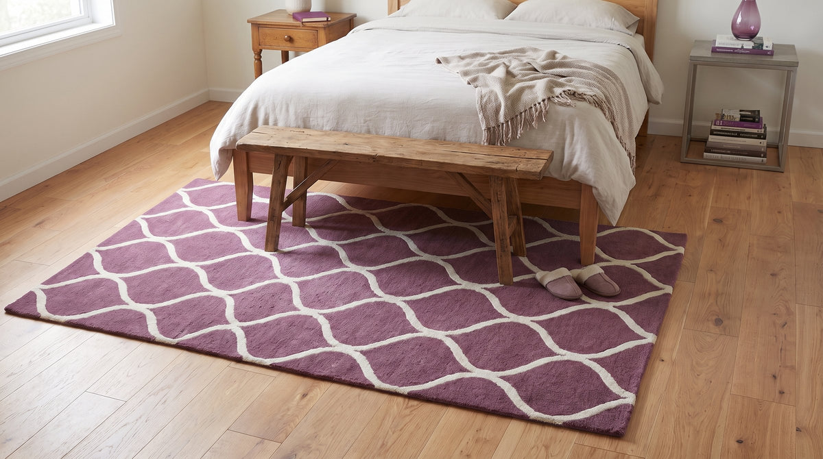 Ava Exquisite Burgundy Hand Tufted Wool Rug in a bedroom