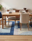 Bespoke Iris Multicolor Hand Tufted Wool Rug in a dining room