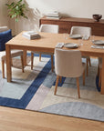 Bespoke Iris Multicolor Hand Tufted Wool Rug in a dining room