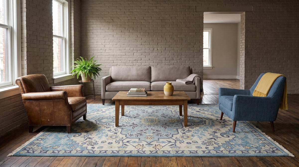 Bianca Oriental Ivory and Blue Hand Knotted Wool Rug in a living room