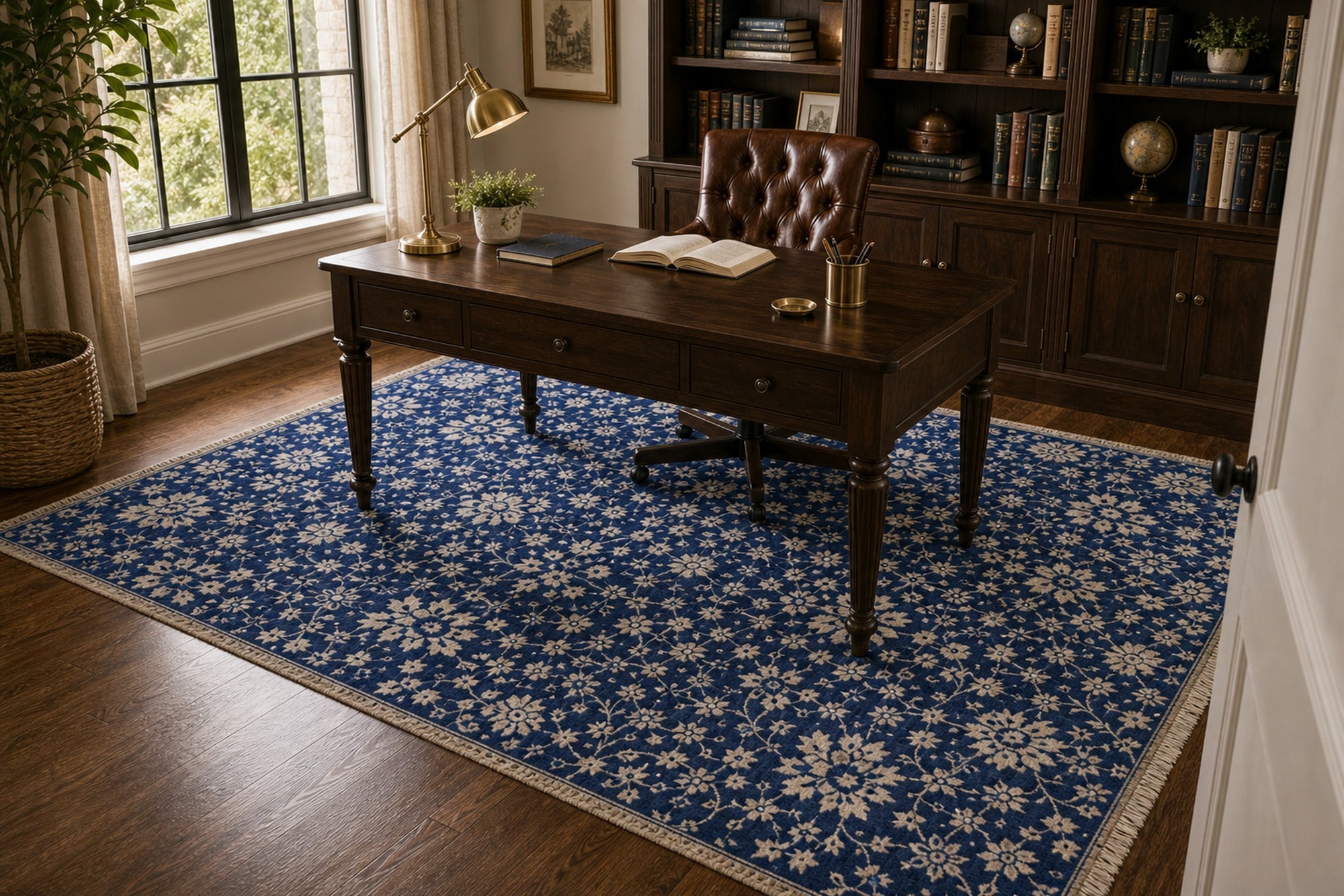 Blue ivory Oushak floral rug styled in a study with a writing desk