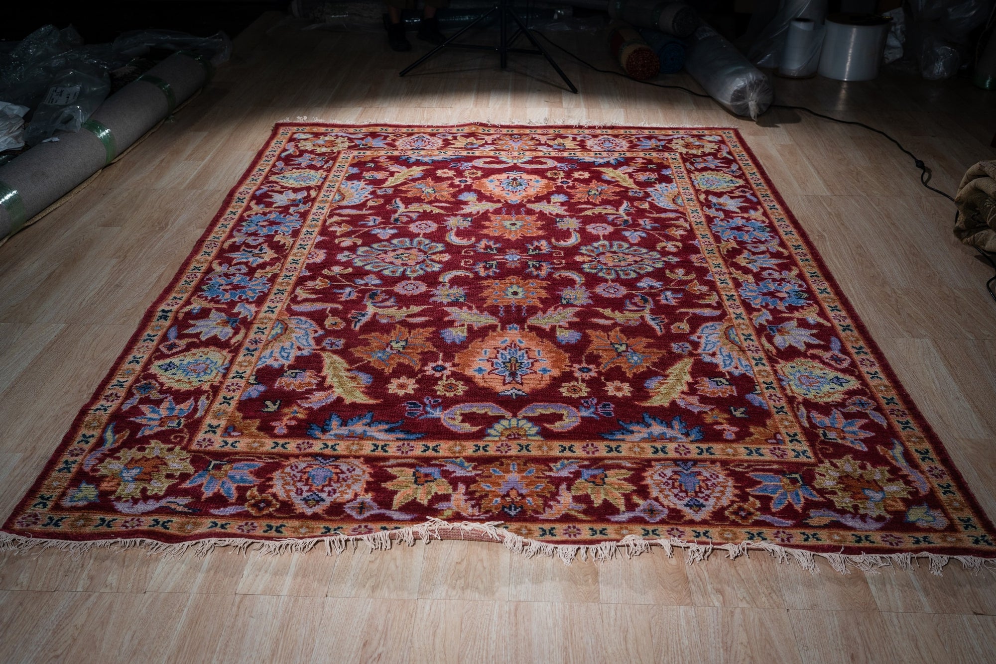 Burgundy Oushak floral wool rug, full view on floor