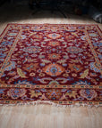 Burgundy Oushak floral wool rug, full view on floor
