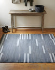 Cassandra Clara Gray and Ivory Flatweave Wool Rug in a entryway