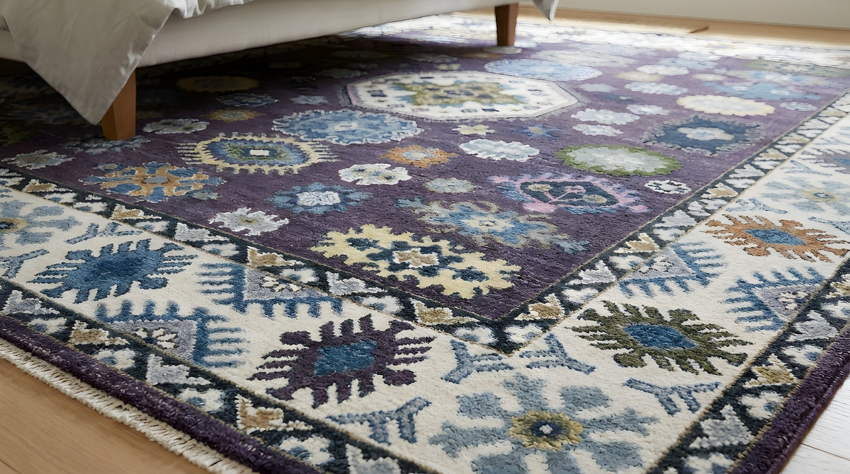 Cassandra Kazak Purple Hand Knotted Wool Rug in a bedroom