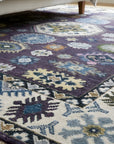 Cassandra Kazak Purple Hand Knotted Wool Rug in a bedroom